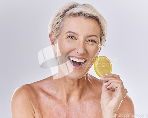 Image of Skincare, health and face of senior lady with a healthy lifestyle holding an organic lemon. Portrait of a happy mature female with wrinkles doing a fresh citrus fruit body care wellness routine.