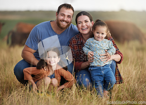 Image of Portrait of happy family on a countryside farm field with cows in the background. Farmer parents bonding with kids on a sustainable agriculture cattle business with a smile and happiness together