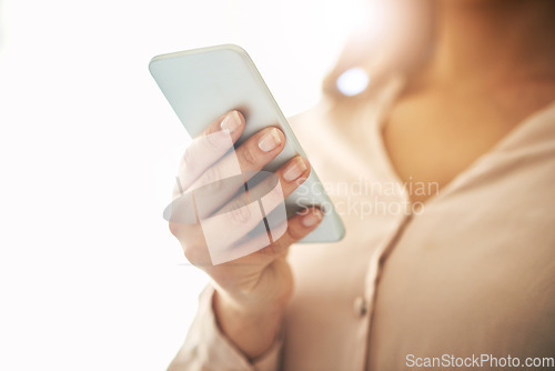 Image of Phone in hand, communication and networking with a woman reading, typing or sending a text message. Closeup of a female browsing social media, surfing the internet and checking news online with flare