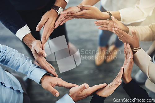 Image of Circle of hands, teamwork and togetherness with a group of business colleagues standing in a team huddle from above. Working together, showing unity and giving support in a meeting for motivation