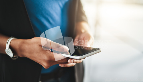 Image of Businesswoman texting on phone, networking on social media and browsing internet at work. Closeup of the hands of a professional employee checking a text, scrolling an online app and reading messages