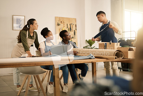 Image of Serious, young and creative clothing designers planning with laptop, working on clothes and learning about material at a studio together. Diverse, thinking and team of workers designing fashion