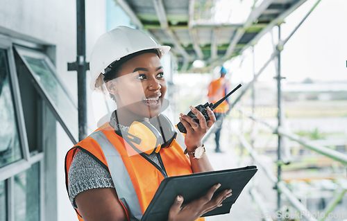 Image of Construction worker with tablet, walkie talkie or radio talking, instructing and checking building progress on development site. Architect manager, female leader or engineer watching infrastructure