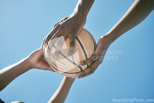 Image of Basketball, sports and competition with players holding a ball against a blue sky with copy space from below. Closeup hands of black male athletes and friends playing or training for a game outside