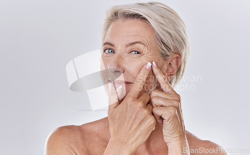 Image of Acne or pimple popping female or woman after night face skincare beauty treatment for healthy and clear skin copy space. Portrait of happy senior woman use cosmetics with hands to target wrinkles