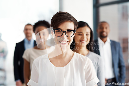 Image of A happy diverse group of smart and successful businesspeople with a satisfied leader or manager. Portrait of a team of corporate professionals smiling about company growth and development