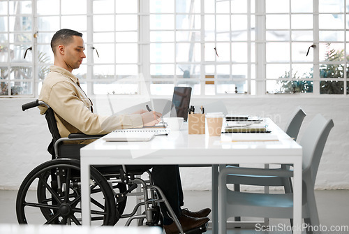 Image of Wheelchair, disabled and handicap business man working, planning and writing ideas in an inclusive, accessible and independent office workplace. Physically impaired, focused and serious entrepreneur