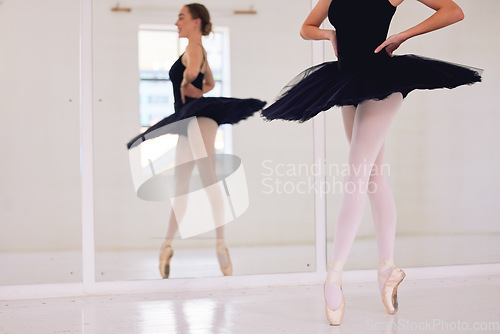 Image of Ballet art performance dancer dancing, training and doing a balance on her feet with pointe shoes in an arts studio hall. Classical, fitness and theatre ballerina on the floor on her tip toes on foot