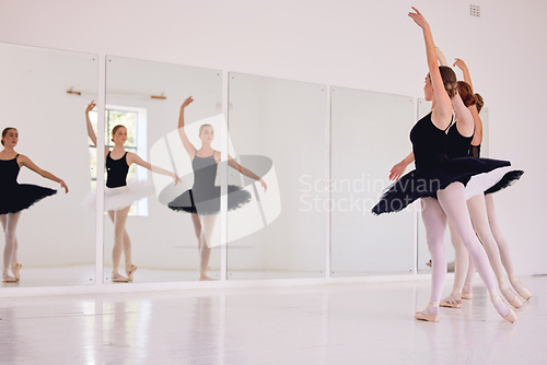 Image of Ballerinas dancing or practicing in a dance studio or class ready for a performance. Elegant dancers training ballet moves by looking in a mirror and preparing for an entertainment gig