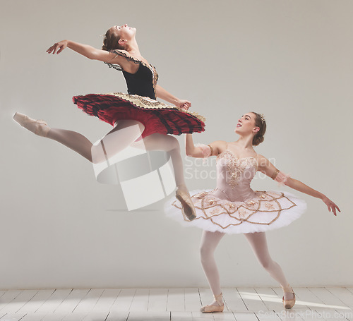 Image of Ballerina, ballet dancers and performance artists jumping in the air with flexibility, motion and balance in a studio. Energy, energetic and classical performers dancing together for fitness in hall