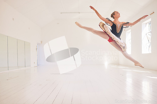 Image of Jumping or leaping female ballerina, ballet dancer or performer in a traditional tutu dress costume in a studio with copy space background. Young professional performer dancing in ballon mid air pose