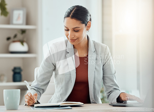 Image of Female manager, boss or CEO writing notes in her diary, marking appointments in her calendar or organizing a schedule. Corporate professional feeling motivated and working at her desk in the office