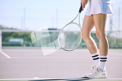 Image of Legs of a female tennis player practicing or training for a match outdoors on the court on a sunny day. Active, fit and athletic female athlete or sportswoman playing a sport for a club