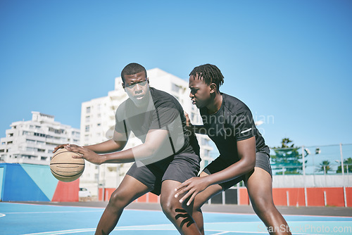 Image of Basketball, fitness and active sports game played by young African men in an outdoor court for exercise. Training, workout and healthy guy friends playing a fun, friendly and athletic sport in summer