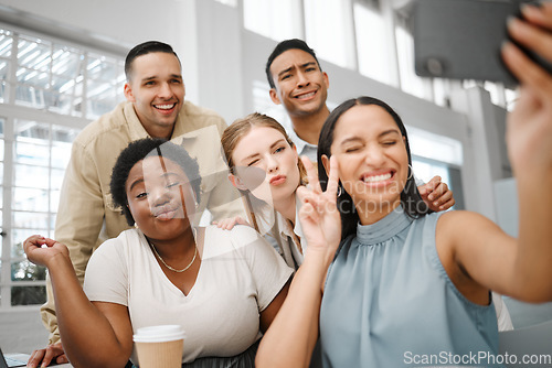 Image of Fun, goofy or playful team selfie on phone and having fun, goofing around or making silly face expressions. Diverse or cheerful group of business friends or creative colleagues posing on social media