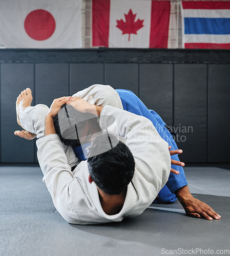 Image of . Male martial arts, fighting at a dojo and holding his opponent. Karate, sports and taekwondo adults training at the gym for a fight. Athlete, aikido and practicing for an international competition.