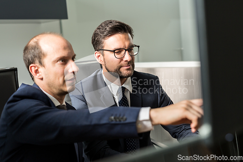 Image of Business team analyzing data at business meeting in modern corporate office.