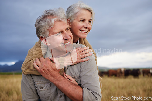 Image of Mature couple embracing and looking happy while bonding outdoors at a farm, carefree and loving. Senior husband and wife having peaceful day in nature, enjoying retirement and relationship