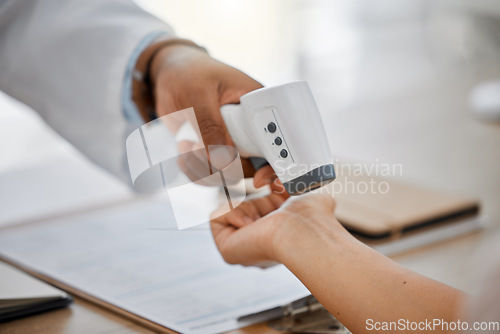 Image of Medical doctor measure with infrared digital thermometer in a clinic consulting appointment for covid. Healthcare worker check for coronavirus for health and safety in hospital office