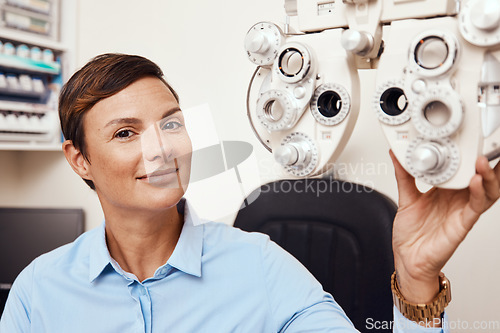 Image of Portrait of professional optometrist, confident and happy in an optometry office preparing equipment for eye checks. Caucasian female health and ophthalmology expert ready to test a patient