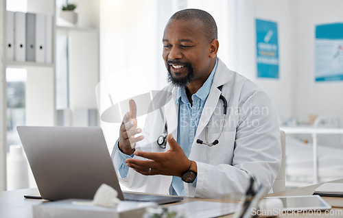 Image of Telemedicine, healthcare and video call with doctor talking on laptop to online patient during a consultation. Happy black professional offering support or medical advice during a medical appointment
