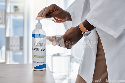 Image of Covid, hand sanitizer and hygiene by doctor, healthcare worker and medical professional in clinic, hospital and wellness center. Closeup of consulting man cleaning virus, bacteria and germs off hands