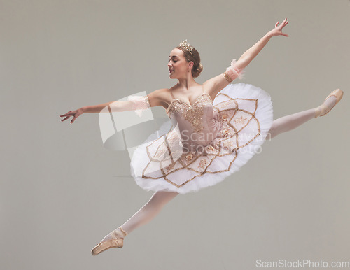 Image of Jumping ballet dancer or ballerina performer dancing in a beautiful, elegant tutu dress or fashion design costume in studio performance. Talented, professional dance artist jump a in ballon pose