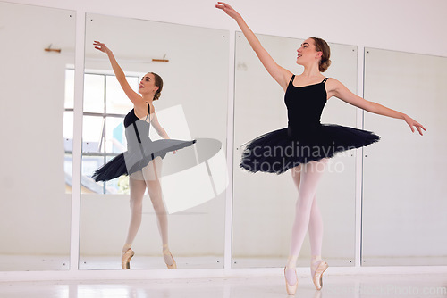 Image of Ballet dancer or ballerina in dance studio practice or training for dancing performance or competition. Elegant, flexible and beautiful young woman in tutu practicing balance and flexibility