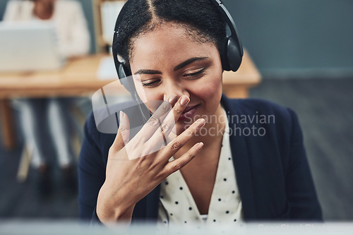 Image of Young call centre agent covers their mouth to hide their smile. The client makes the employee happy with their positive feedback or joke. Building a professional and friendly relationship online.