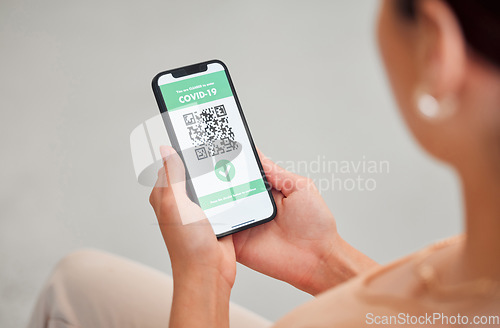 Image of Covid vaccine passport, digital certificate and immunity travel pass displayed with qr code on phone screen for health clearance. Woman, tourist and traveler with mobile app for medical vaccination