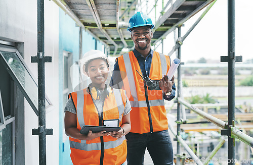Image of Builder and engineer working together as a construction team on a building site and standing on scaffolding. Portrait of a man and woman in a hardhat and vest at work on a new development project