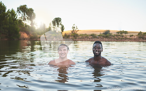 Image of Vacation, friends and having fun while swimming in a lake and enjoying summer. Portrait of happy and diverse guys smiling while enjoying the water and friendship on their holiday and nature travel