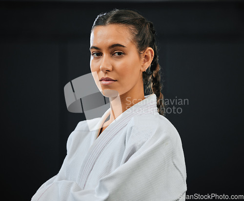 Image of . Karate, judo or taekwondo woman in white kimono for martial arts, jiu jitsu and kung fu against a black studio background. Portrait of a determined, serious and focused fighter ready for combat.