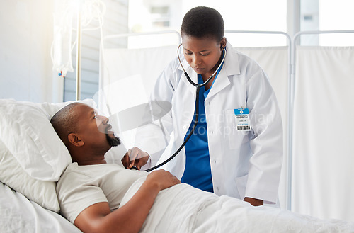 Image of Medical doctor doing heart health checkup on patient in bed, listening for healthy heartbeat and consulting black man after surgery at hospital. Sick male person doing tests with healthcare worker