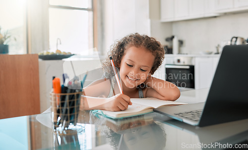 Image of Homework, education and student online learning writing and drawing in her kindergarten school notebook at home. Smile, happy and creative girl studying, fun and working on laptop via house internet