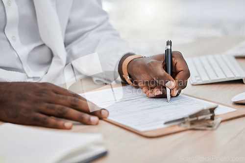 Image of Doctor writing a prescription or medical history, record or insurance in his office and working on a health document. Closeup of a healthcare black male professional or GP signing a contract