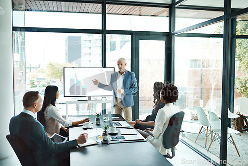 Image of Businesspeople attending a presentation in the boardroom about growth, innovation and development with graphs in a boardroom. Mature man showing great leadership while talking about company vision