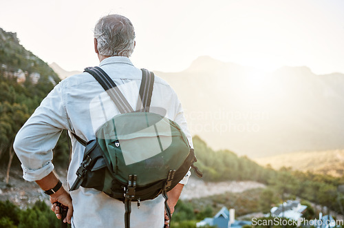 Image of . Rear view of exploring, active and adventure senior man standing with a backpack after a hike, enjoying the landscape and forest nature. Male hiker looking at nature environment sunrise view.