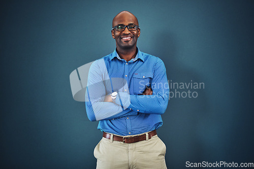 Image of Confident, proud business man feeling happiness, confidence and motivation indoors. Portrait of a smiling male tech worker ready to work in a leadership role in his corporate company