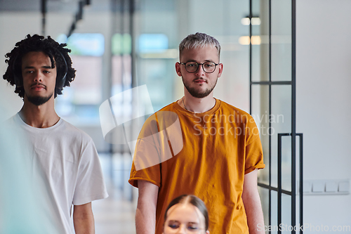 Image of A modern portrait captures a blue-haired businessman wearing glasses, exuding creativity and professionalism, within the ambiance of a startup coworking office