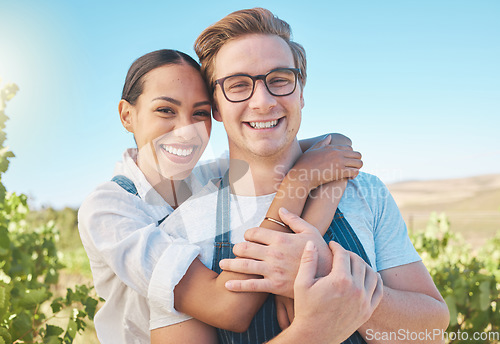 Image of Interracial couple, love and happy man and woman in hug or embrace on wine tasting farm. Portrait of fun, trust or playful people on sustainability countryside, vineyard estate and agriculture field