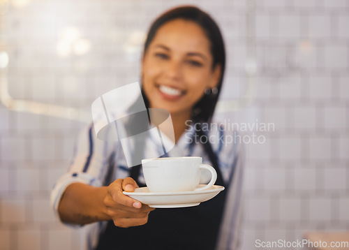 Image of Small business owner, barista manager or waitress in coffee shop, cafe or retail shop with friendly smile and customer service. Restaurant cashier hands cup of coffee, tea or espresso to POV consumer