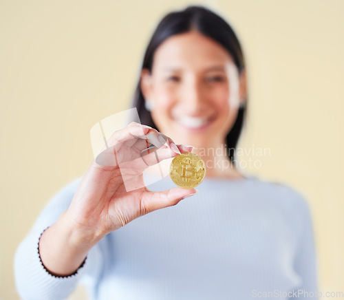 Image of Bitcoin, money and coin of a woman trader or broker holding a real cryptocurrency or virtual token. Female investor happy about her investment, trading and getting value for financial growth.