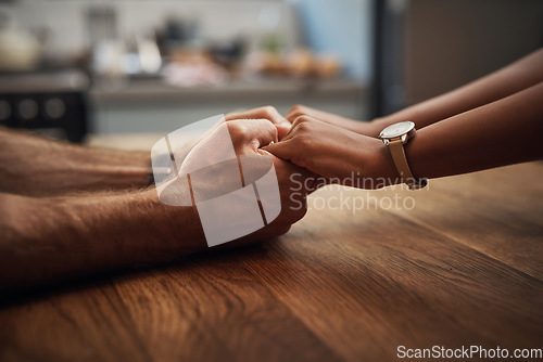 Image of Couple holding hands in support, grief and healing together on a wooden table at home. Closeup of a caring partner in sorrow due to cancer and expressing feelings of compassion in a house