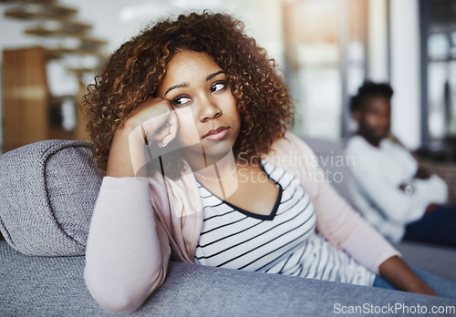 Image of Relationship issues, communication problems and divorce talk of a couple after a fight at home. Upset female feeling frustrated on a living room couch. Annoyed couple on a sitting on a sofa