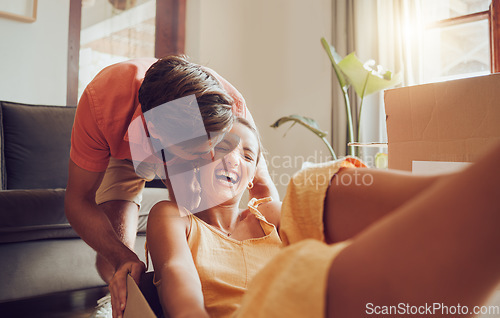 Image of Playful and fun couple moving into their new house, celebrating by being goofy and fooling around. Affectionate boyfriend and girlfriend enjoying their freedom, laughing, bonding and playing