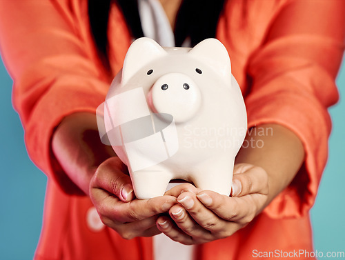 Image of Closeup of hands holding a piggy bank with her savings and financial investments. Stylish, trendy and elegant female with future planning, looking after her wealth growth developments.