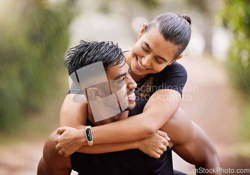 Image of Wet, fitness couple playing in the rain during fun romantic outdoor training, running or healthy workout exercise in park. Happy sport people with a smile or caring man giving woman a piggyback ride