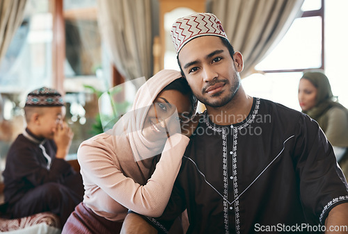 Image of Married muslim couple together with family celebrating islamic religious holiday event wishing an eid mubarak or ramadan kareem. Traditional, and cultural in love husband and wife sitting at home