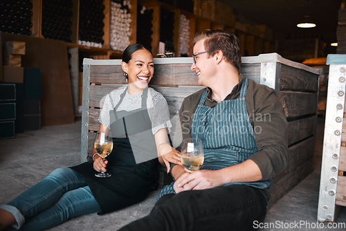 Image of Laughing couple, wine tasting date and drinking alcohol with glasses in remote farm distillery, winery estate or countryside. Happy, flirt or bonding interracial man and woman enjoying vineyard drink